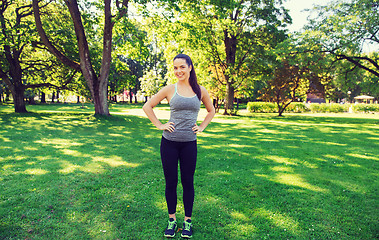 Image showing happy young woman exercising outdoors