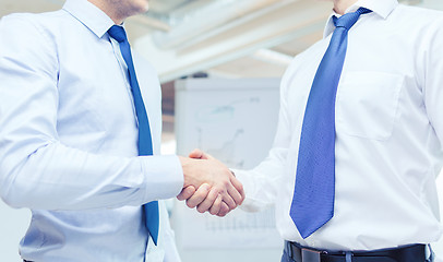 Image showing two businessmen shaking hands in office