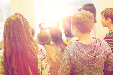 Image showing group of kids with teacher and computer at school