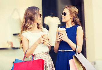 Image showing young women with shopping bags and coffee at shop