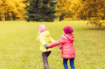 Image showing happy little girls running outdoors