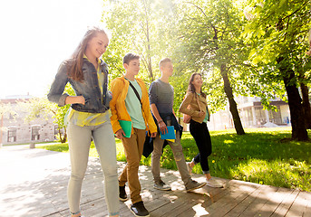 Image showing group of happy teenage students walking outdoors