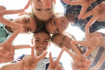 Image showing group of happy children showing v sign in circle
