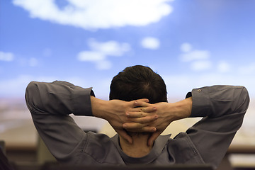 Image showing young man dreaming clouds on presentation