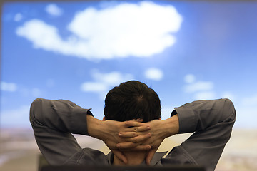 Image showing young man dreaming clouds on presentation