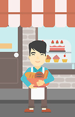 Image showing Baker holding basket with bakery products.