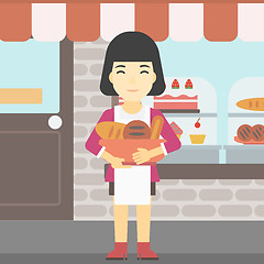 Image showing Baker holding basket with bakery products.