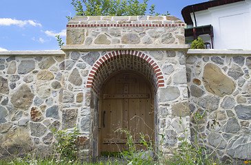 Image showing Wood gate and stone wall