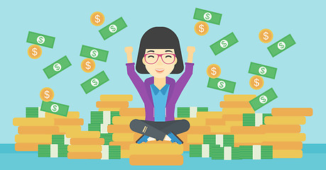 Image showing Happy business woman sitting on coins.