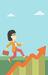 Image showing Business woman running along the growth graph.