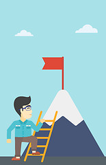 Image showing Businessman climbing on mountain.