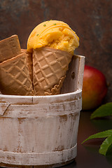 Image showing Homemade mango ice cream in waffle cone