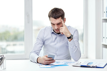 Image showing close up of businessman with smartphone