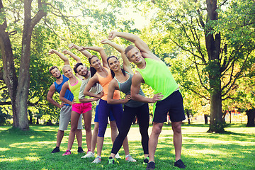 Image showing group of friends or sportsmen exercising outdoors