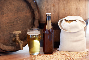 Image showing close up of beer barrel, glass, bottle and malt