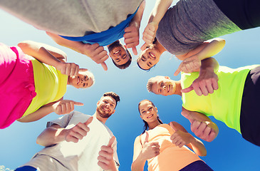 Image showing group of happy sporty friends showing thumbs up