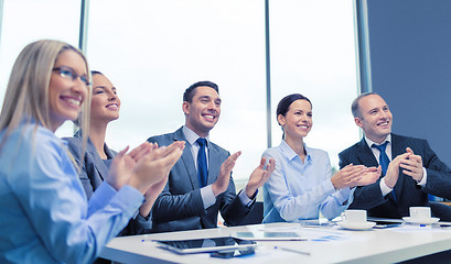 Image showing business team with laptop clapping hands