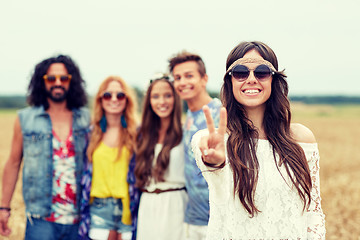 Image showing happy young hippie friends showing peace outdoors