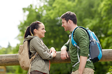 Image showing smiling couple with backpacks in nature