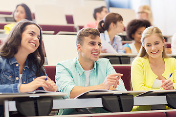 Image showing group of students with notebooks in lecture hall