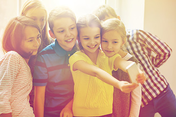 Image showing group of school kids taking selfie with smartphone