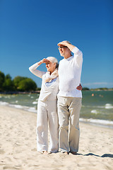 Image showing happy senior couple hugging on summer beach