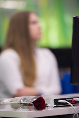 Image showing rose flower on famale students table on class