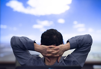 Image showing young man dreaming clouds on presentation