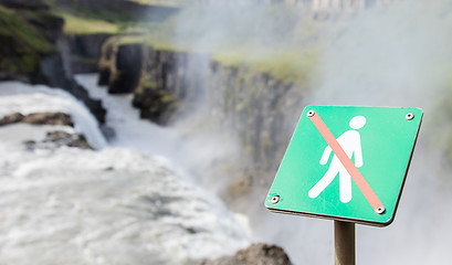 Image showing Forbidden to walk over here - Iceland - Fierce waterfall in back