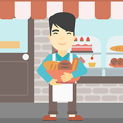 Image showing Baker holding basket with bakery products.