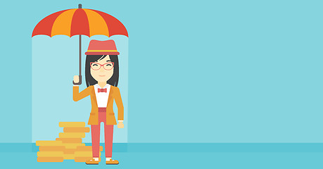 Image showing Business woman with umbrella protecting money.
