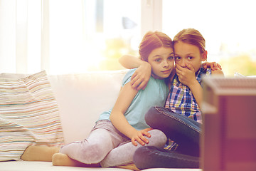 Image showing scared little girls watching horror on tv at home