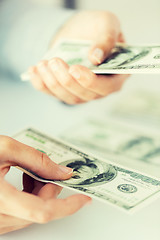 Image showing close up of woman hands counting us dollar money