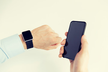 Image showing close up of hands with smart phone and watch