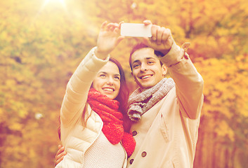 Image showing smiling couple hugging in autumn park