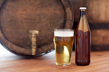 Image showing close up of old beer barrel, glass and bottle