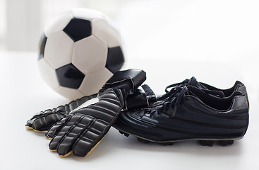 Image showing close up of soccer ball, boots and gloves on table