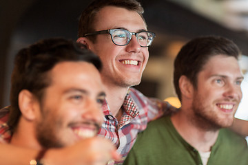 Image showing happy male friends watching football at bar or pub