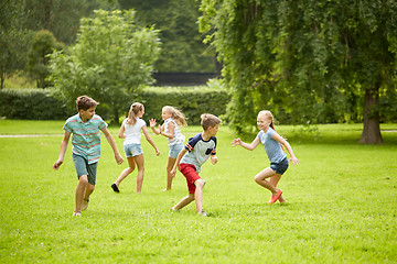 Image showing happy kids running and playing game outdoors