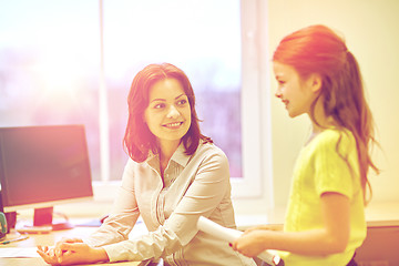 Image showing school girl with notebook and teacher in classroom