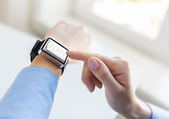 Image showing close up of hands with coding on smart watch