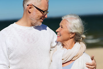 Image showing happy senior couple hugging on summer beach