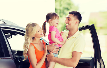 Image showing happy family with child laughing at car parking