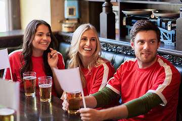 Image showing fans or friends watching football at sport bar