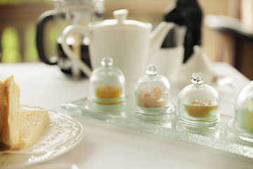 Image showing close up of tea time set with jam on table