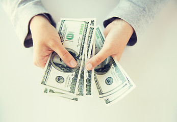 Image showing close up of woman hands counting us dollar money