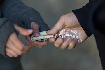 Image showing close up of addict buying dose from drug dealer