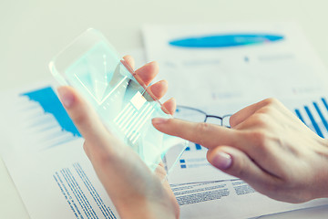 Image showing close up of woman with transparent smartphone