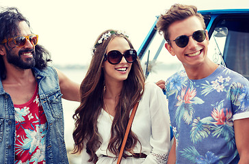 Image showing smiling young hippie friends over minivan car