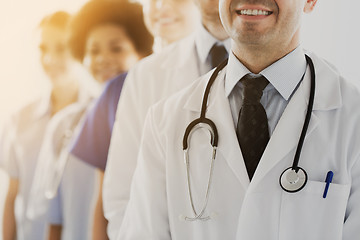 Image showing close up of happy doctors with stethoscope